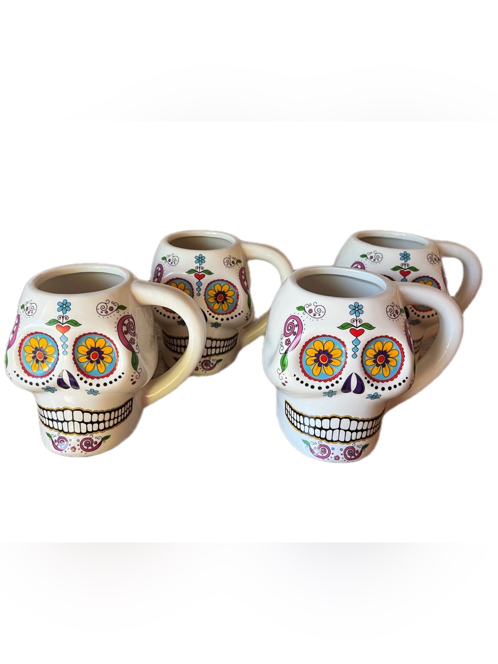 Beautiful set of skull-shaped mugs in picturesque colors